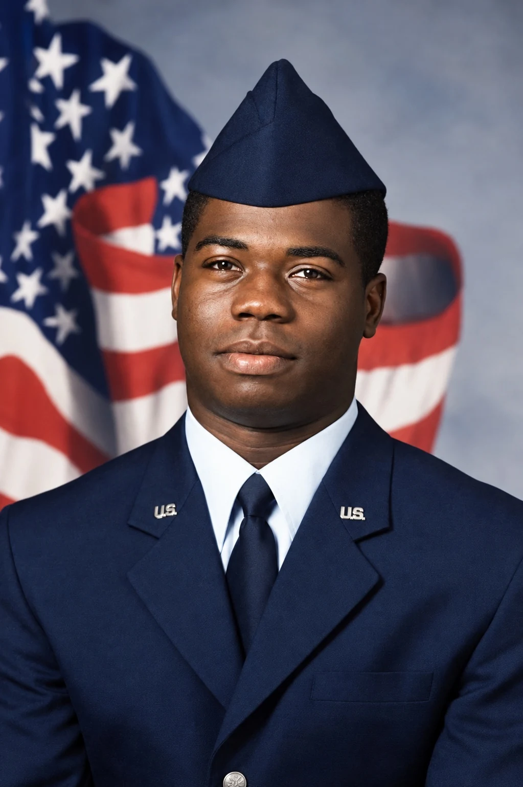 Official Air Force portrait of Chief Seals as a young Airman, in service dress before the flag.